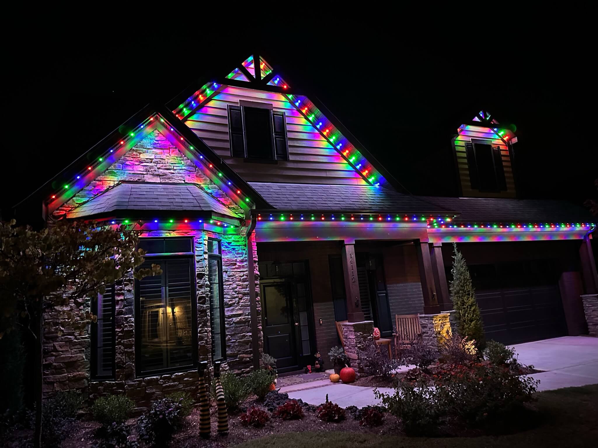 A house is adorned with colorful lights during the nighttime