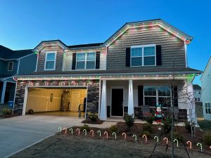 A decorated house with festive lights and candy cane accents
