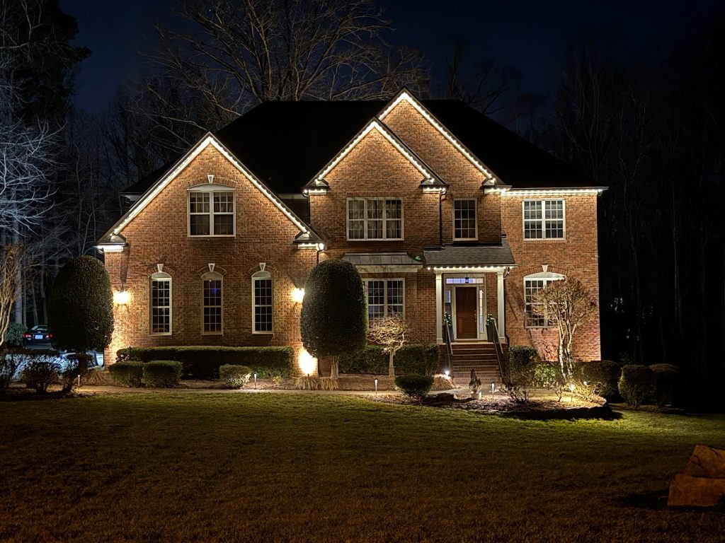 Permanent Christmas lights Georgetown beautifully illuminate a brick house at night