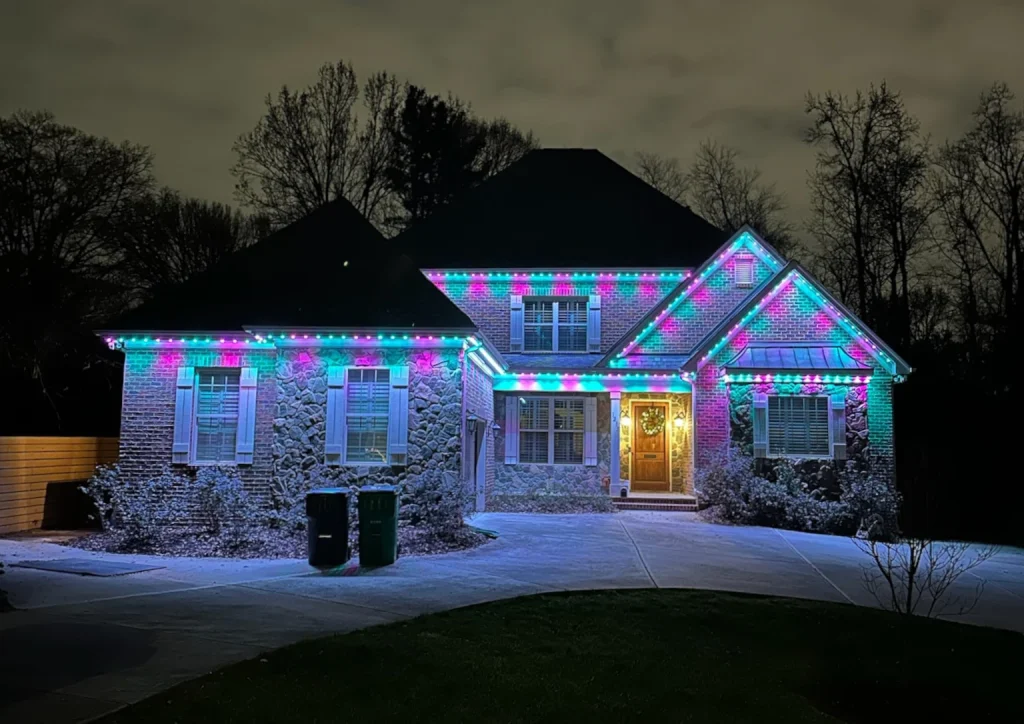 A beautifully lit house adorned with colorful lights against a dark night sky